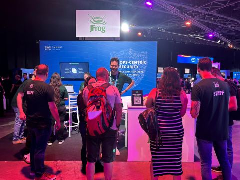 Dennis at the JFrog booth during AWS Summit, talking with attendees about DevSecOps.